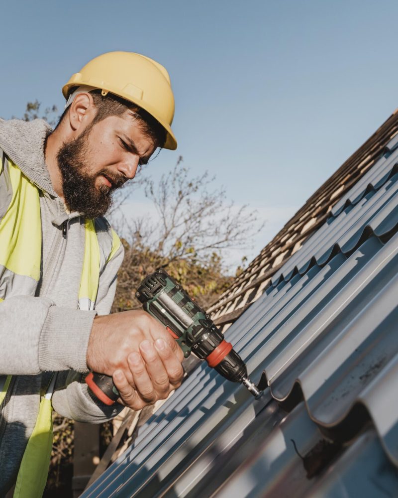 sideways-man-working-roof-with-drill